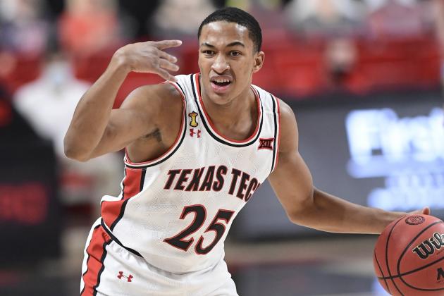 Texas Tech's Nimari Burnett (25) signals a teammate during the first half of an NCAA college basketball game against Kansas in Lubbock, Texas, Thursday, Dec. 17, 2020. (AP Photo/Justin Rex)