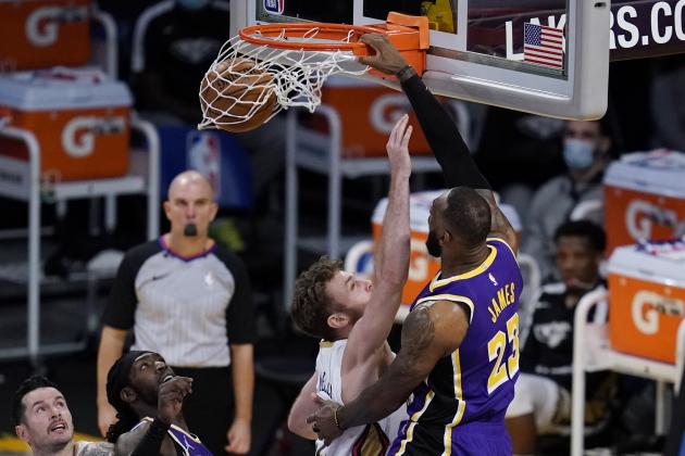 Los Angeles Lakers forward LeBron James (23) dunks against New Orleans Pelicans forward Nicolo Melli, center, during the third quarter of an NBA basketball game Friday, Jan. 15, 2021, in Los Angeles. (AP Photo/Ashley Landis)