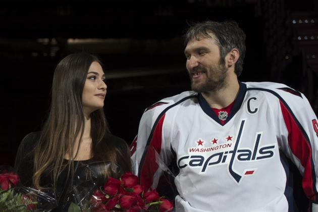 Washington Capitals' Alex Ovechkin, right, smiles at his wife Nastya Shubskaya during a ceremony for recording his 1,000th NHL point, before an NHL hockey game against the Los Angeles Kings, Sunday, Feb. 5, 2017, in Washington. (AP Photo/Molly Riley)