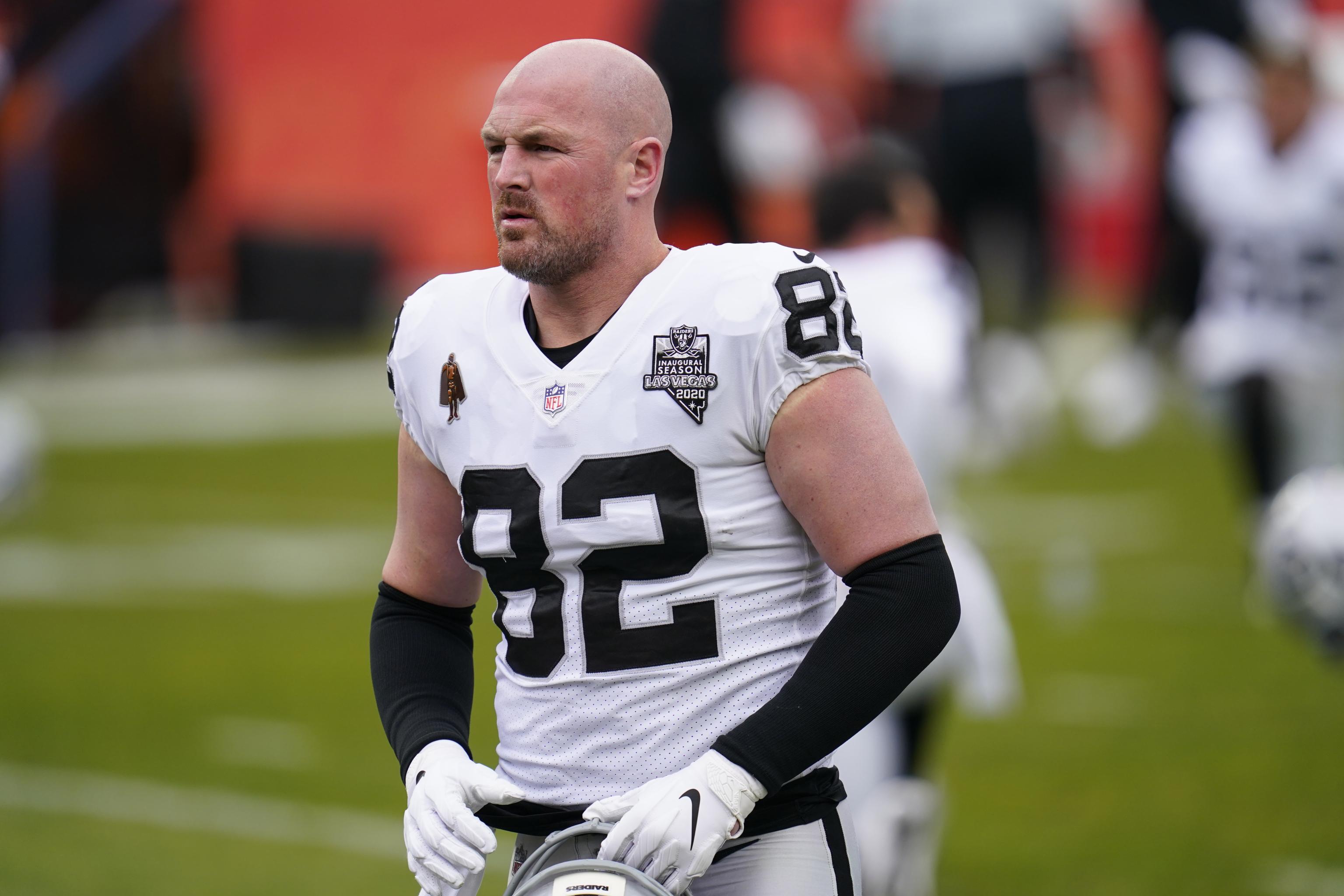 Former Dallas Cowboy Jason Witten, left center, now the football