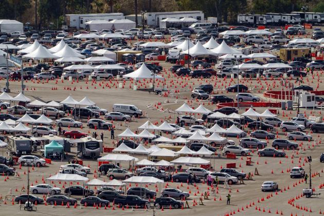 FILE - In this Jan. 27, 2021, file photo, Drivers wait in line at a mega COVID-19 vaccination site set up in the parking lot of Dodger Stadium in Los Angeles. One of the largest vaccination sites in the country temporarily shut down Saturday because dozen of protesters blocked the entrance, stalling hundreds of motorists who had been waiting in line for hours, the Los Angeles Times reported.  (AP Photo/Damian Dovarganes, File)