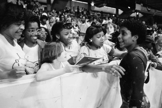 FILE - In this June 5, 1983, file photo, Dianne Durham, right, of Gary, Ind., gives autographs after winning the women's title at the McDonald's U.S.A. Gymnastic Championships at the University of Illinois in Chicago. Durham, the first Black woman to win a USA Gymnastics national championship, died on Thursday, Feb. 4, 2021, She was 52. (AP Photo/Lisa Genesen, File)