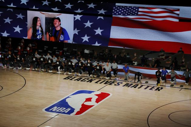Players take a knee during the national anthem before Game 4 of an NBA basketball first-round playoff series between the Los Angeles Clippers and the Dallas Mavericks, Sunday, Aug. 23, 2020, in Lake Buena Vista, Fla. (Kevin C. Cox/Pool Photo via AP) Players take a knee during the national anthem before Game 4 of an NBA basketball first-round playoff series between the Los Angeles Clippers and the Dallas Mavericks, Sunday, Aug. 23, 2020, in Lake Buena Vista, Fla. (Kevin C. Cox/Pool Photo via AP)