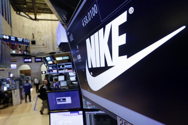 FILE - In this Wednesday, March 22, 2017, file photo, the Nike logo appears above the post where it trades on the floor of the New York Stock Exchange. On Thursday, June 15, 2017, Nike said it plans to cut about 1,400 jobs, reduce the number of sneaker styles it offers by a quarter and sell more shoes directly to customers online. The company says the changes to its business structure will help it offer more products to customers faster. (AP Photo/Richard Drew, File)