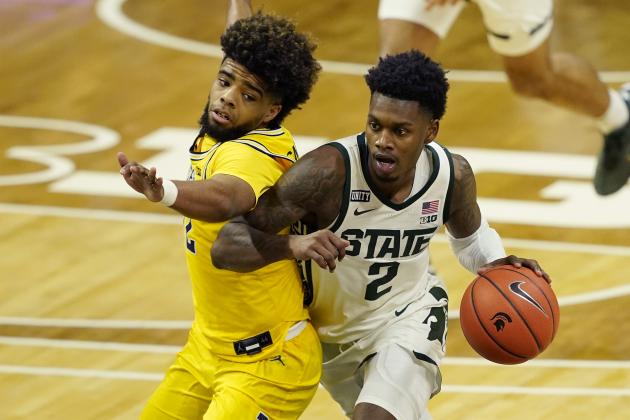 Michigan State guard Rocket Watts (2) drives as Michigan guard Mike Smith defends during the second half of an NCAA college basketball game, Sunday, March 7, 2021, in East Lansing, Mich. (AP Photo/Carlos Osorio)
