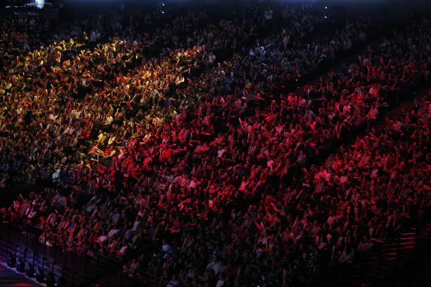 Spectators watch the final of League of Legends tournament between Team G2 Esports and Team FunPlus Phoenix, in Paris, Sunday, Nov. 10, 2019. The biggest e-sports event of the year saw a Chinese team, FunPlus Phoenix, crowned as world champions of the video game League of Legends. Thousands of fans packed a Paris arena for the event, which marked another step forward for the growing esports business. (AP Photo/Thibault Camus)