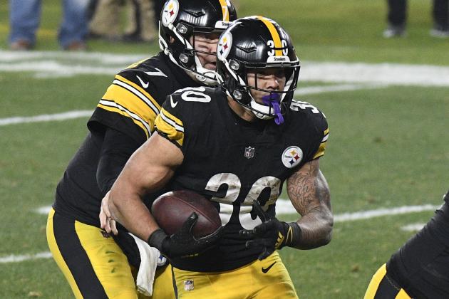 Pittsburgh Steelers running back James Conner (30) takes a handoff from quarterback Ben Roethlisberger and scores on a one-yard run during the first half of an NFL wild-card playoff football game against the Cleveland Browns in Pittsburgh, Sunday, Jan. 10, 2021. (AP Photo/Don Wright)