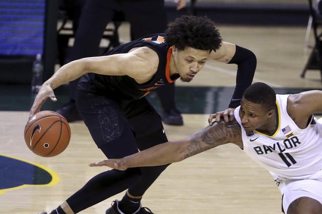 Baylor guard Mark Vital (11) tries to steal the ball from Oklahoma State guard Cade Cunningham (2) in the second half of an NCAA college basketball game, Thursday, March 4, 2021, in Waco, Texas. (AP Photo/Jerry Larson)