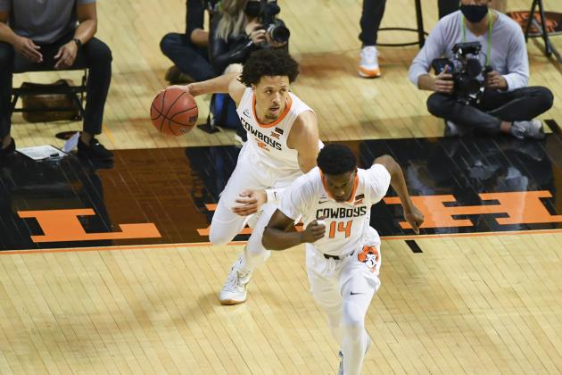 Oklahoma State guard Cade Cunningham (2) and Oklahoma State guard Bryce Williams (14) advance the ball during an NCAA college basketball game Monday, Feb. 22, 2021, in Stillwater, Okla. Oklahoma State defeated Texas Tech in overtime. (AP Photo/Brody Schmidt)