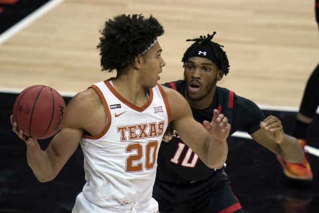 Texas forward Jericho Sims (20) looks to pass while covered by Texas Tech Red forward Tyreek Smith (10) during the first half of an NCAA college basketball game in the quarterfinal round of the Big 12 men's tournament in Kansas City, Mo., Thursday, March 11, 2021. (AP Photo/Orlin Wagner)