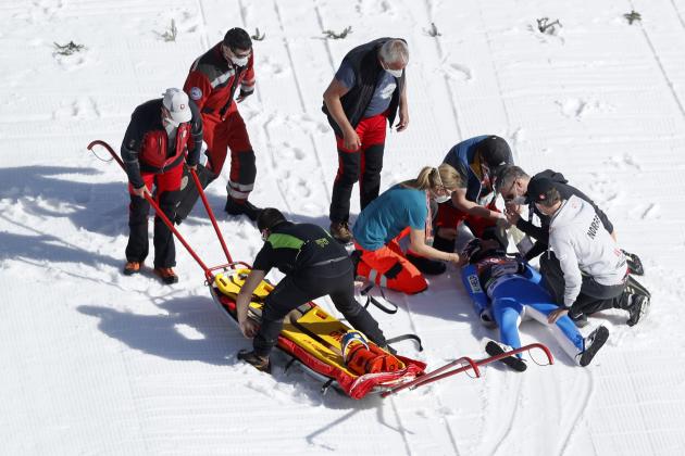 Healthcare workers attend to Norway's Daniel Andre Tande after he crashed during the ski flying individual World Cup event in Planica, Slovenia, Thursday, March 25, 2021. (AP Photo)
