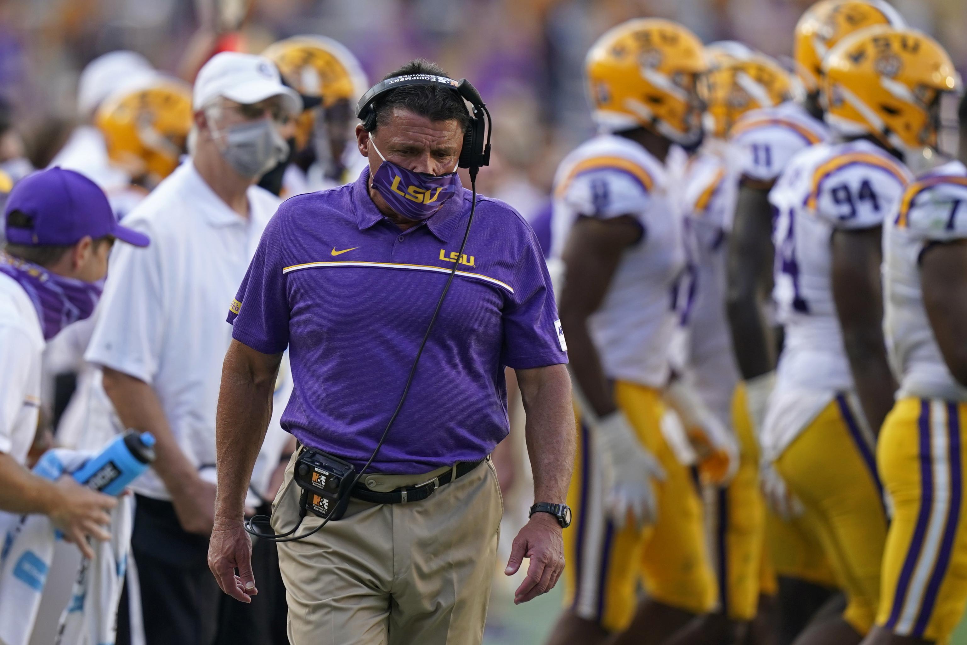 Former LSU head football coach, Ed Orgeron, right, talks to his