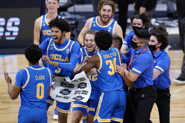 UCLA players celebrate after beating Alabama 88-78 in overtime of a Sweet 16 game in the NCAA men's college basketball tournament at Hinkle Fieldhouse in Indianapolis, Sunday, March 28, 2021. (AP Photo/AJ Mast)