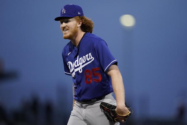 Los Angeles Dodgers starting pitcher Dustin May (85) smiles after fielding a ball during a spring training baseball game against the Chicago Cubs Thursday, March 25, 2021, in Mesa, Ariz. (AP Photo/Ashley Landis)
