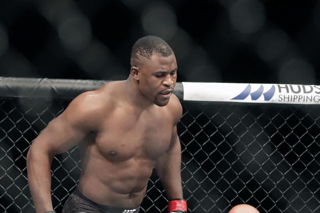 CORRECTS TO JAIRZINHO ROZENSTRUIK NOT JAIRZINHO ROZENSTRUCK - Francis Ngannou, left, walks alway after knocking out Jairzinho Rozenstruik, bottom, in the first round of a UFC 249 mixed martial arts bout Saturday, May 9, 2020, in Jacksonville, Fla. (AP Photo/John Raoux)