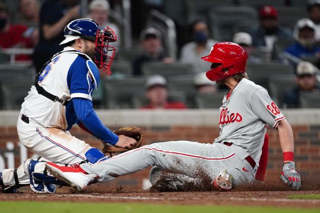 Philadelphia Phillies' Alec Bohm (28) beats the tag from Atlanta Braves catcher Travis d'Arnaud (16) to score the winning run on a Didi Gregorius sacrifice fly in the ninth inning of a baseball game Sunday, April 11, 2021, in Atlanta. (AP Photo/John Bazemore) Philadelphia Phillies' Alec Bohm (28) beats the tag from Atlanta Braves catcher Travis d'Arnaud (16) to score the winning run on a Didi Gregorius sacrifice fly in the ninth inning of a baseball game Sunday, April 11, 2021, in Atlanta. (AP Photo/John Bazemore)