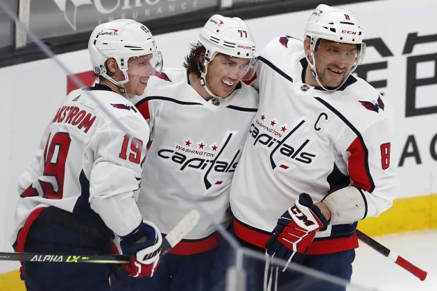 Washington Capitals' T.J. Oshie (77) celebrates his goal with teammates Nicklas Backstrom (19) and Alex Ovechkin (8) during the third period of an NHL hockey game against the Boston Bruins, Sunday, April 11, 2021, in Boston. (AP Photo/Michael Dwyer)