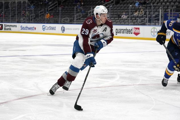 Colorado Avalanche's Nathan MacKinnon handles the puck during the first period of an NHL hockey game against the St. Louis Blues Thursday, April 22, 2021, in St. Louis. (AP Photo/Jeff Roberson)
