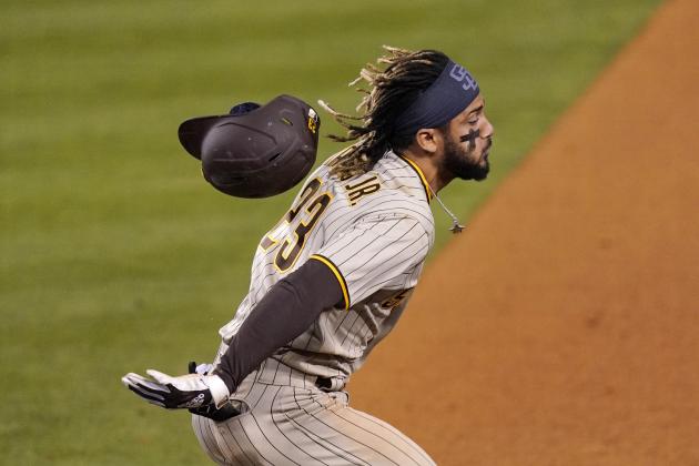 San Diego Padres' Fernando Tatis Jr. loses his helmet after making it to first for an RBI single during the ninth inning of a baseball game against the Los Angeles Dodgers Friday, April 23, 2021, in Los Angeles. (AP Photo/Mark J. Terrill)