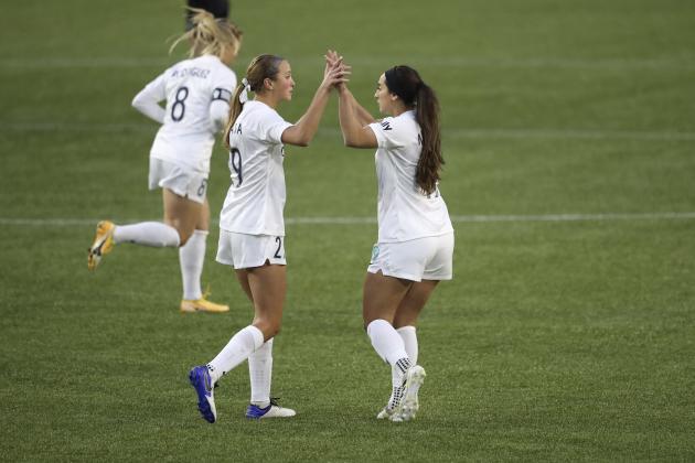 Kansas City's Kate Del Fava (29) and Michelle Maemone (19) high five prior to the first half of an NWSL Challenge Cup soccer match against Portland Thorns FC on Friday, April 9, 2021, in Portland, Ore. (AP Photo/Amanda Loman)