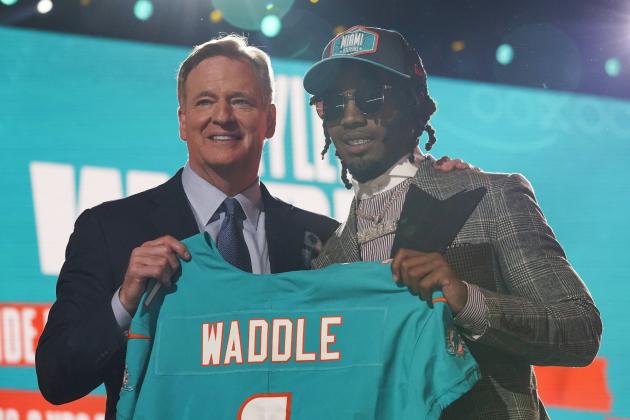 Alabama wide receiver Jaylen Waddle, right, holds a team jersey with NFL Commissioner Roger Goodell after being chosen by the Miami Dolphins with the sixth pick in the NFL football draft Thursday April 29, 2021, in Cleveland. (AP Photo/Tony Dejak)
