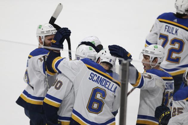 St. Louis Blues' Ryan O'Reilly (90) is surrounded by teammates in celebration after scoring in overtime against the Minnesota Wild during an NHL hockey game Thursday, April 29, 2021, in St. Paul, Minn. St. Louis won 5-4. (AP Photo/Stacy Bengs) St. Louis Blues' Ryan O'Reilly (90) is surrounded by teammates in celebration after scoring in overtime against the Minnesota Wild during an NHL hockey game Thursday, April 29, 2021, in St. Paul, Minn. St. Louis won 5-4. (AP Photo/Stacy Bengs)