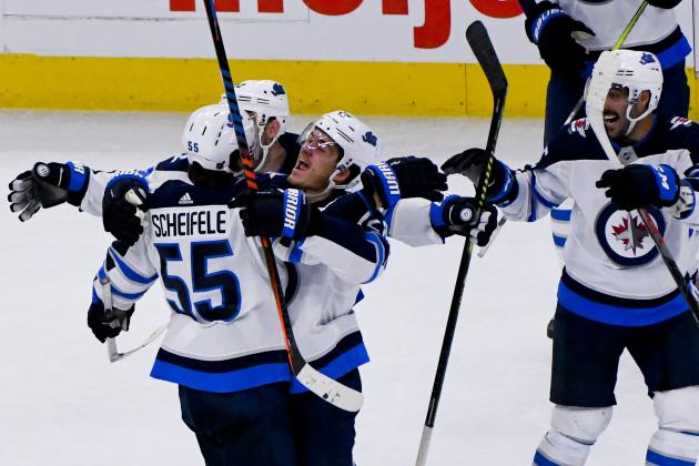 Winnipeg Jets center Mark Scheifele (55) is hugged by center Jack Roslovic, center, after scoring the winning goal during overtime of an NHL hockey game against the Chicago Blackhawks, Saturday, Oct. 12, 2019, in Chicago. (AP Photo/Matt Marton)