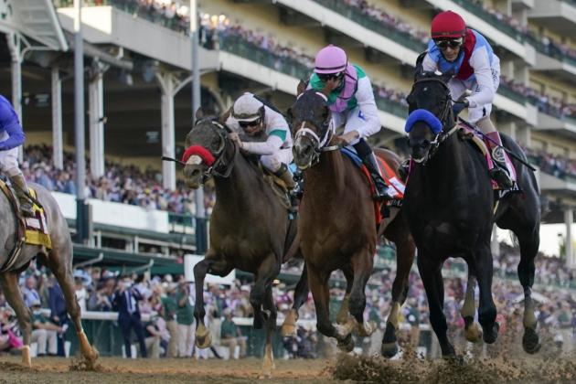 John Velazquez riding Medina Spirit, right, leads Florent Geroux on Mandaloun, Flavien Prat riding Hot Rod Charlie and Luis Saez on Essential Quality to win the 147th running of the Kentucky Derby at Churchill Downs, Saturday, May 1, 2021, in Louisville, Ky. (AP Photo/Jeff Roberson)