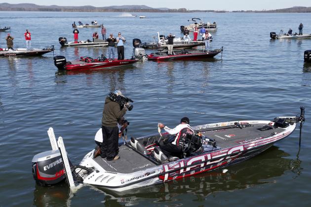 Randall Tharp, Port Saint Joe, Fla., holds up a bass for spectators following him on the second day of the Bassmaster Classic, Saturday, Feb. 22, 2014, in Guntersville, Ala. Tharp was bumped from first to second by 1 ounce by Edwin Evers, Talala, Okla. The field will be cut to the top 25 anglers for the final day of competition. (AP Photo/Hal Yeager)