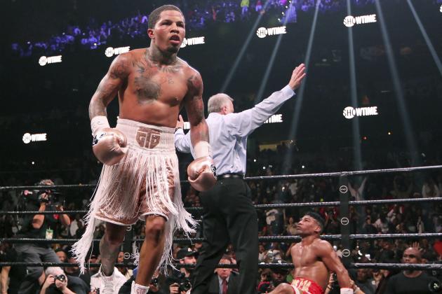 CORRECTS SURNAME OF REFEREE TO REISS, INSTEAD OF WEISS - Gervonta Davis, left, heads to the corner as Yuriorkis Gamboa, right, looks up at referee Jack Reiss during the WBA secondary lightweight title boxing bout early Sunday, Dec. 29, 2019, in Atlanta. Davis won when the fight was stopped in the 12th round. (AP Photo/Tami Chappell)