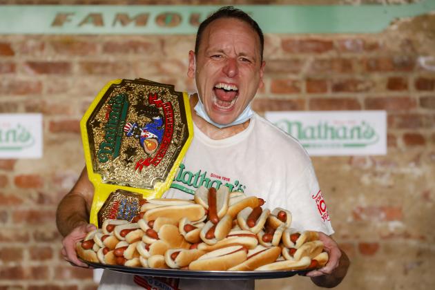 Competitive eater Joey Chestnut celebrates after setting a new world record with 75 hot dogs to win the men's division of the Nathan's Famous July Fourth hot dog eating contest, Saturday, July 4, 2020, in the Brooklyn borough of New York. (AP Photo/John Minchillo)