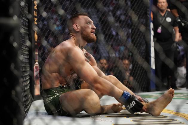 Conor McGregor holds his left ankle while fighting Dustin Poirier during a UFC 264 lightweight mixed martial arts bout Saturday, July 10, 2021, in Las Vegas. (AP Photo/John Locher)