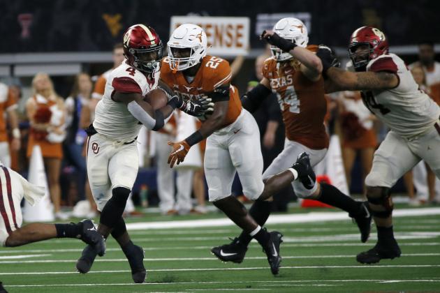 Oklahoma Sooners running back Trey Sermon (4) tries to avoid a tackle by Texas Longhorns safety B.J. Foster (25) during the second half of the NCAA Big 12 Conference football championship, Saturday, Dec. 1, 2018, in Arlington, Texas. Oklahoma defeated Texas 39-27. (AP Photo/Roger Steinman) Oklahoma Sooners running back Trey Sermon (4) tries to avoid a tackle by Texas Longhorns safety B.J. Foster (25) during the second half of the NCAA Big 12 Conference football championship, Saturday, Dec. 1, 2018, in Arlington, Texas. Oklahoma defeated Texas 39-27. (AP Photo/Roger Steinman)