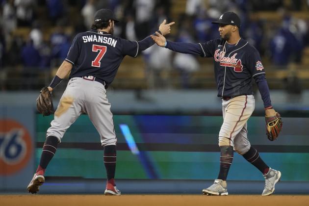 Atlanta Braves shortstop Dansby Swanson (7) congratulates Atlanta Braves' Eddie Rosario after in Game 4 of baseball's National League Championship Series Wednesday, Oct. 20, 2021, in Los Angeles. The Braves defeated the Dodgers 9-2 and lead the series 3-1 games. (AP Photo/Ashley Landis)