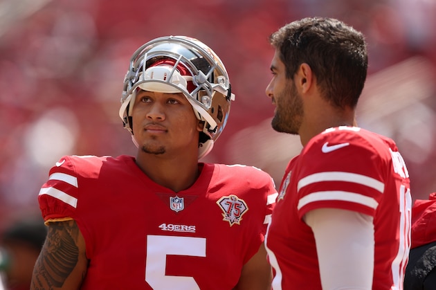 SANTA CLARA, CALIFORNIA - AUGUST 29: Jimmy Garoppolo #10 and Trey Lance #5 of the San Francisco 49ers talk to each other on the sidelines before their preseason game against the Las Vegas Raiders at Levi's Stadium on August 29, 2021 in Santa Clara, California. (Photo by Ezra Shaw/Getty Images)