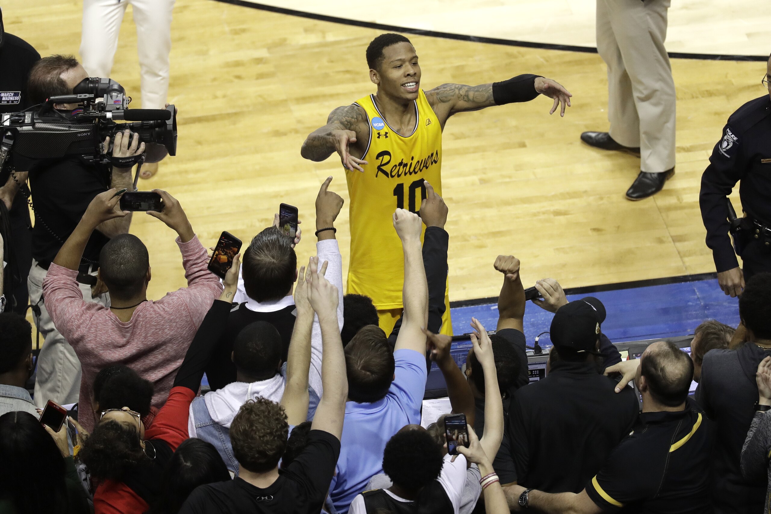 UMBC's Jairus Lyles (10) celebrates with fans after the team's 74-54 win over Virginia in a first-round game in the NCAA men's college basketball tournament in Charlotte, N.C., Friday, March 16, 2018. (AP Photo/Chuck Burton)