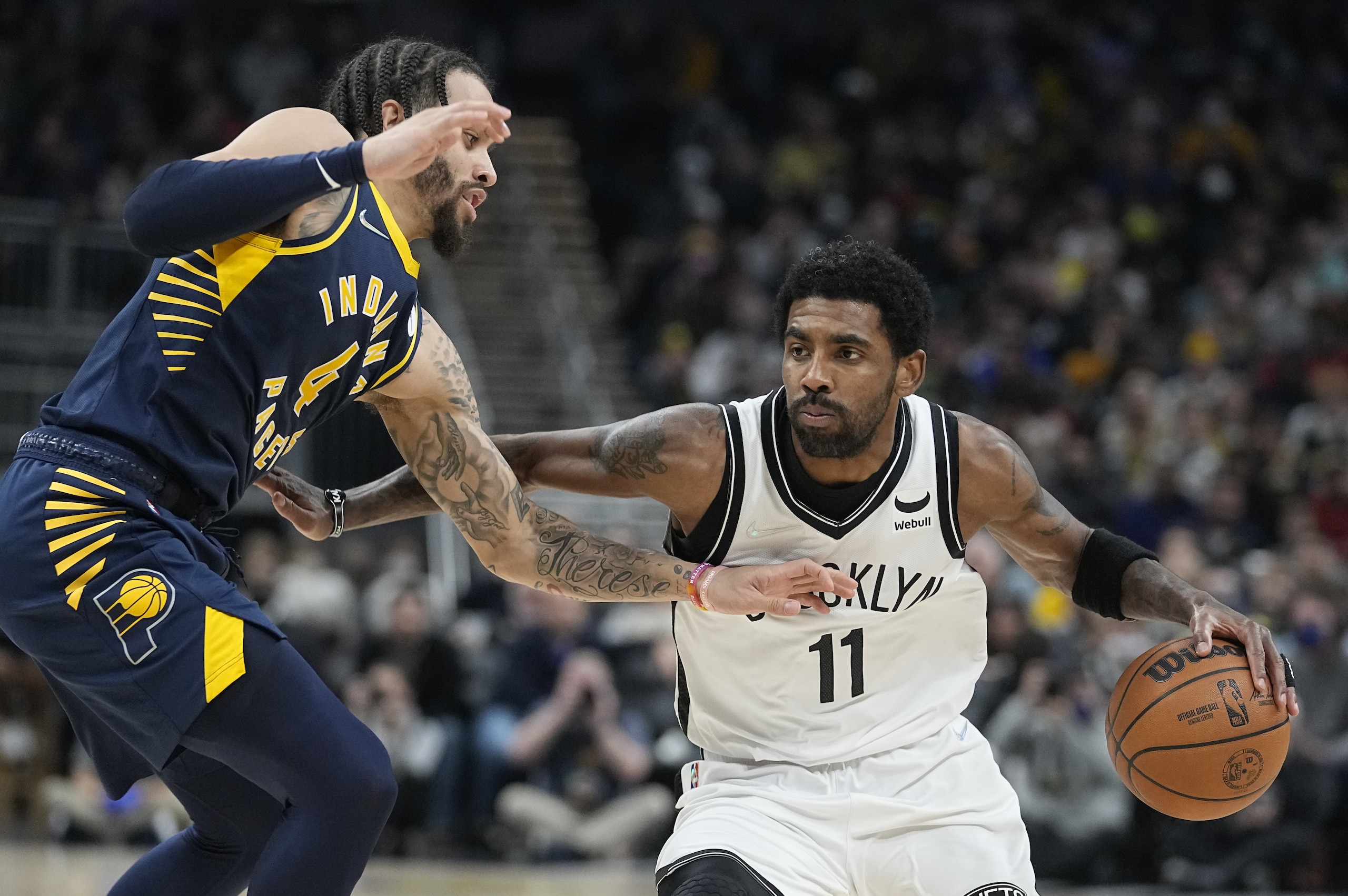 Brooklyn Nets' Kyrie Irving (11) is defended by Indiana Pacers' Duane Washington Jr. (4) during the first half of an NBA basketball game Wednesday, Jan. 5, 2022, in Indianapolis. (AP Photo/Darron Cummings) Brooklyn Nets' Kyrie Irving (11) is defended by Indiana Pacers' Duane Washington Jr. (4) during the first half of an NBA basketball game Wednesday, Jan. 5, 2022, in Indianapolis. (AP Photo/Darron Cummings)