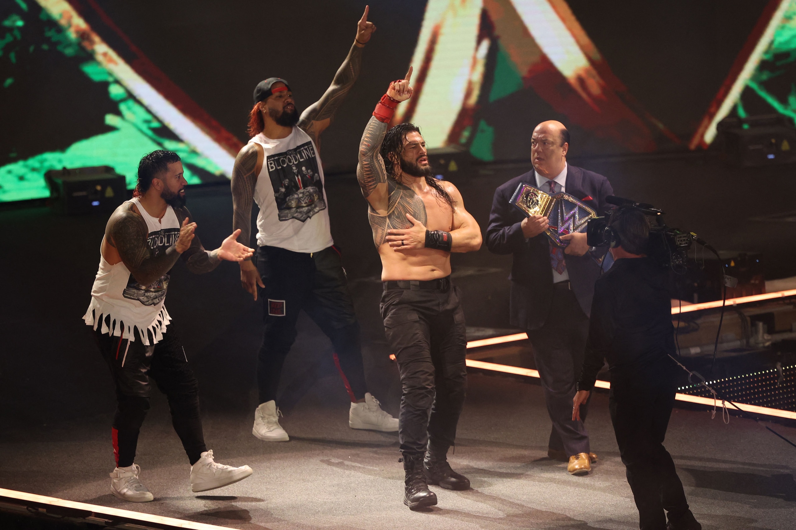 Roman Reigns (2nd-R) celebrates his win during the World Wrestling Entertainment (WWE) Crown Jewel pay-per-view in the Saudi capital Riyadh on October 21, 2021. (Photo by Fayez Nureldine / AFP) (Photo by FAYEZ NURELDINE/AFP via Getty Images)