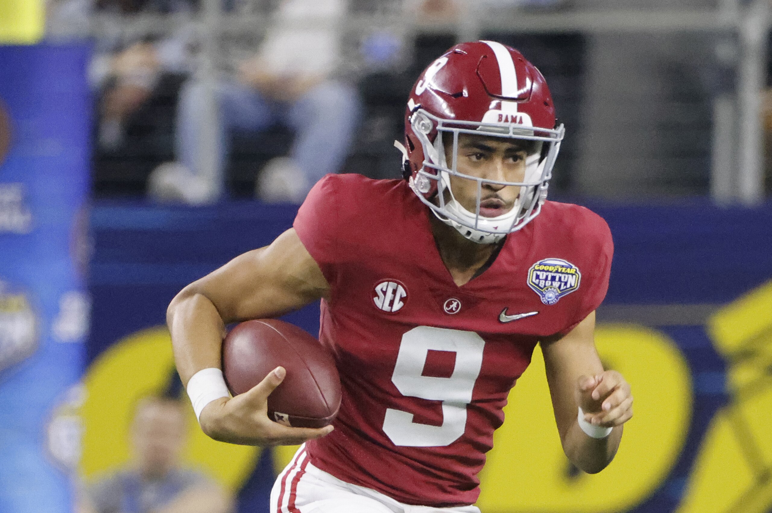 Alabama quarterback Bryce Young (9) runs with the ball during the Cotton Bowl NCAA College Football Playoff semifinal game, Friday, Dec. 31, 2021, in Arlington, Texas. (AP Photo/Michael Ainsworth)
