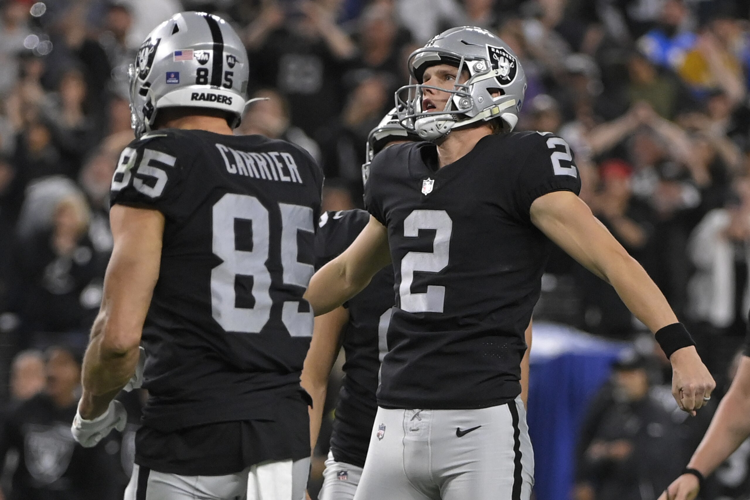 Las Vegas Raiders kicker Daniel Carlson (2) celebrates after kicking the game-winning field goal against the Los Angeles Chargers during overtime of an NFL football game, Sunday, Jan. 9, 2022, in Las Vegas. (AP Photo/David Becker)