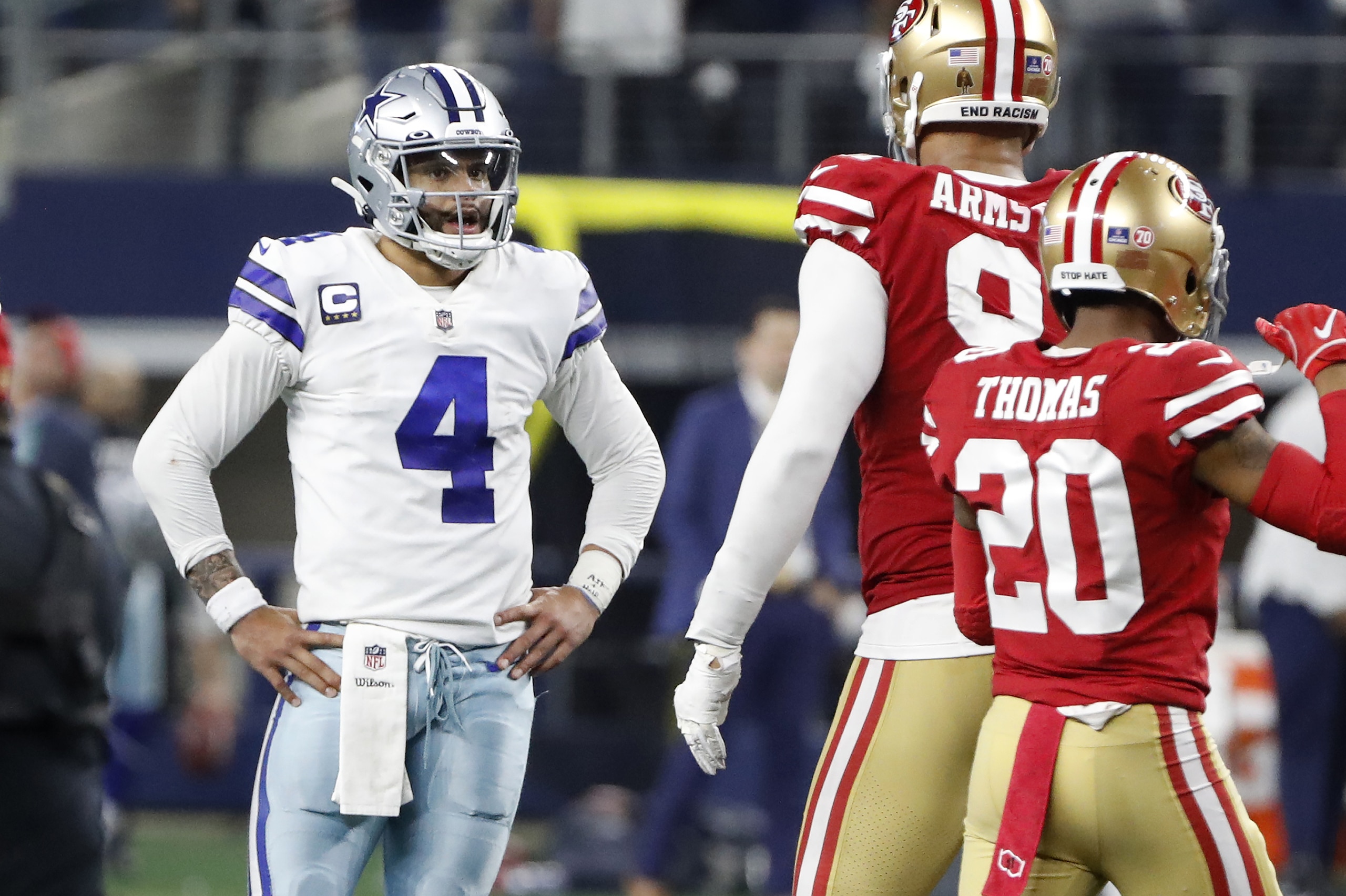 Dallas Cowboys quarterback Dak Prescott (4) reacts next to San Francisco 49ers defensive end Arik Armstead, middle, and cornerback Ambry Thomas (20) after the final play of an NFL wild-card playoff football game in Arlington, Texas, Sunday, Jan. 16, 2022. (AP Photo/Roger Steinman)
