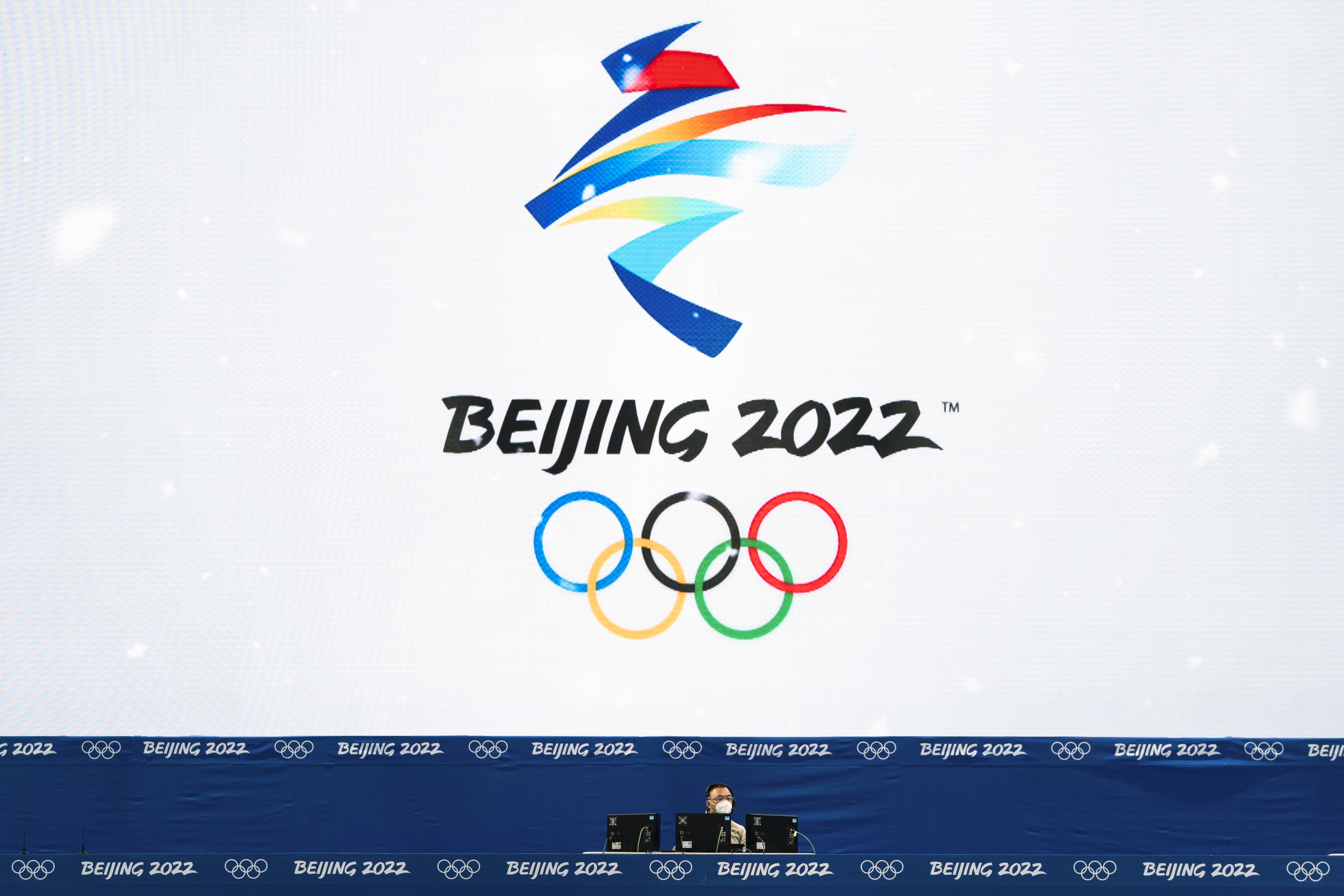 A technician is dwarfed by a large screen with a Beijing 2022 logo on it while working at the National Aquatics Center, a venue for curling events at the 2022 Winter Olympics, Saturday, Jan. 29, 2022, in Beijing. (AP Photo/Jae C. Hong) A technician is dwarfed by a large screen with a Beijing 2022 logo on it while working at the National Aquatics Center, a venue for curling events at the 2022 Winter Olympics, Saturday, Jan. 29, 2022, in Beijing. (AP Photo/Jae C. Hong)