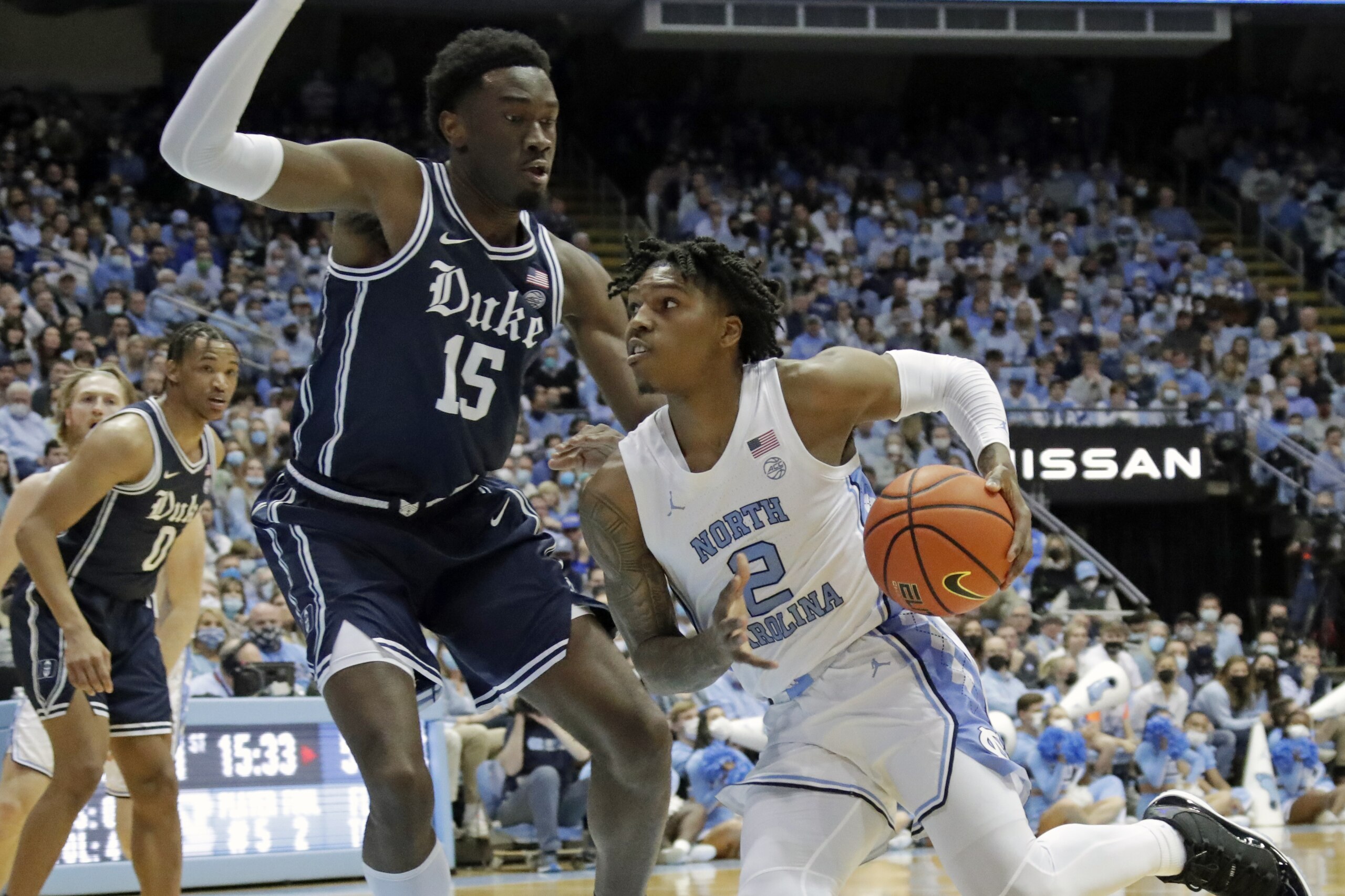 North Carolina guard Caleb Love (2) drives against Duke center Mark Williams (15) during the first half of an NCAA college basketball game, Saturday, Feb. 5, 2022, in Chapel Hill, N.C. (AP Photo/Chris Seward)
