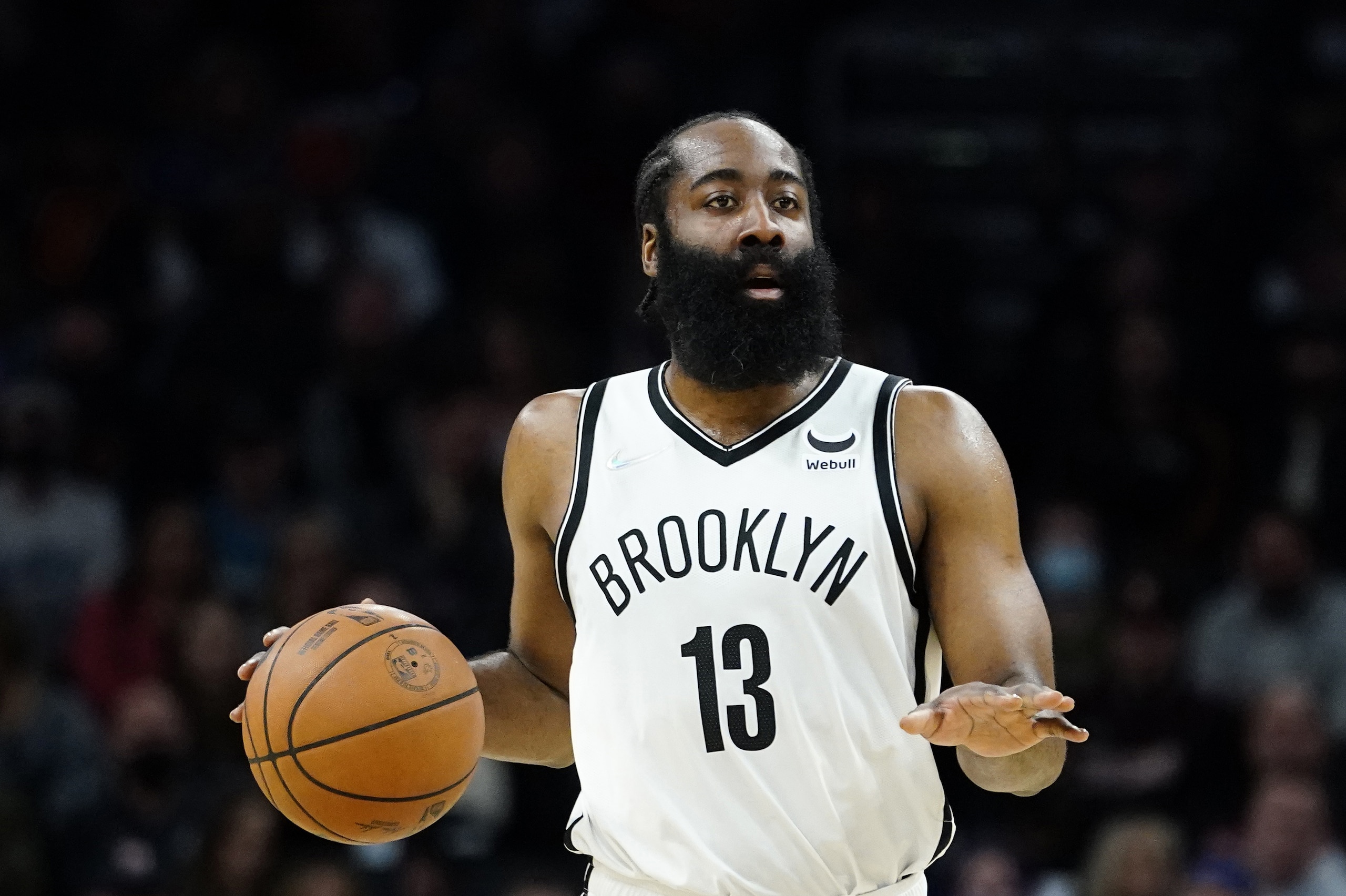 Brooklyn Nets guard James Harden (13) looks to pass against the Phoenix Suns during the first half of an NBA basketball game, Tuesday, Feb. 1, 2022, in Phoenix. (AP Photo/Matt York)