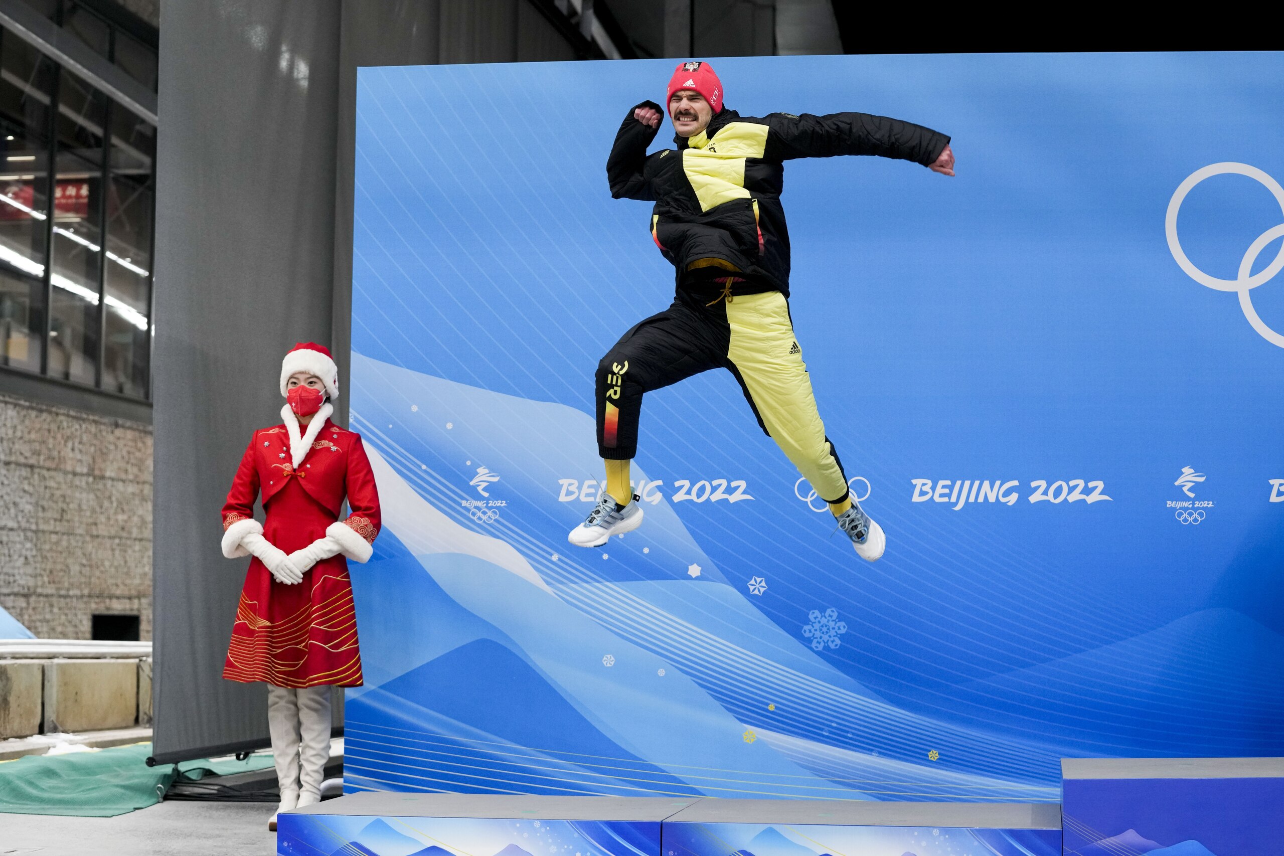 Axel Jungk, of Germany, celebrates winning the silver medal in the men's skeleton at the 2022 Winter Olympics, Friday, Feb. 11, 2022, in the Yanqing district of Beijing. (AP Photo/Mark Schiefelbein)