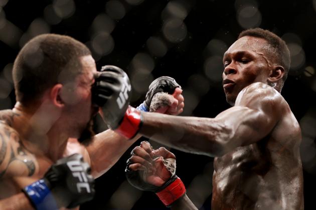 HOUSTON, TEXAS - FEBRUARY 12: Israel Adesanya of Nigeria punches Robert Whittaker of Australia in their middleweight championship fight during UFC 271 at Toyota Center on February 12, 2022 in Houston, Texas. (Photo by Carmen Mandato/Getty Images)