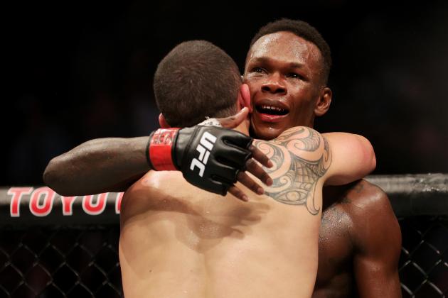 HOUSTON, TEXAS - FEBRUARY 12: Israel Adesanya (R) of Nigeria embraces Robert Whittaker of Australia after their middleweight championship fight during UFC 271 at Toyota Center on February 12, 2022 in Houston, Texas. Adesanya defended his title by unanimous decision. (Photo by Carmen Mandato/Getty Images)