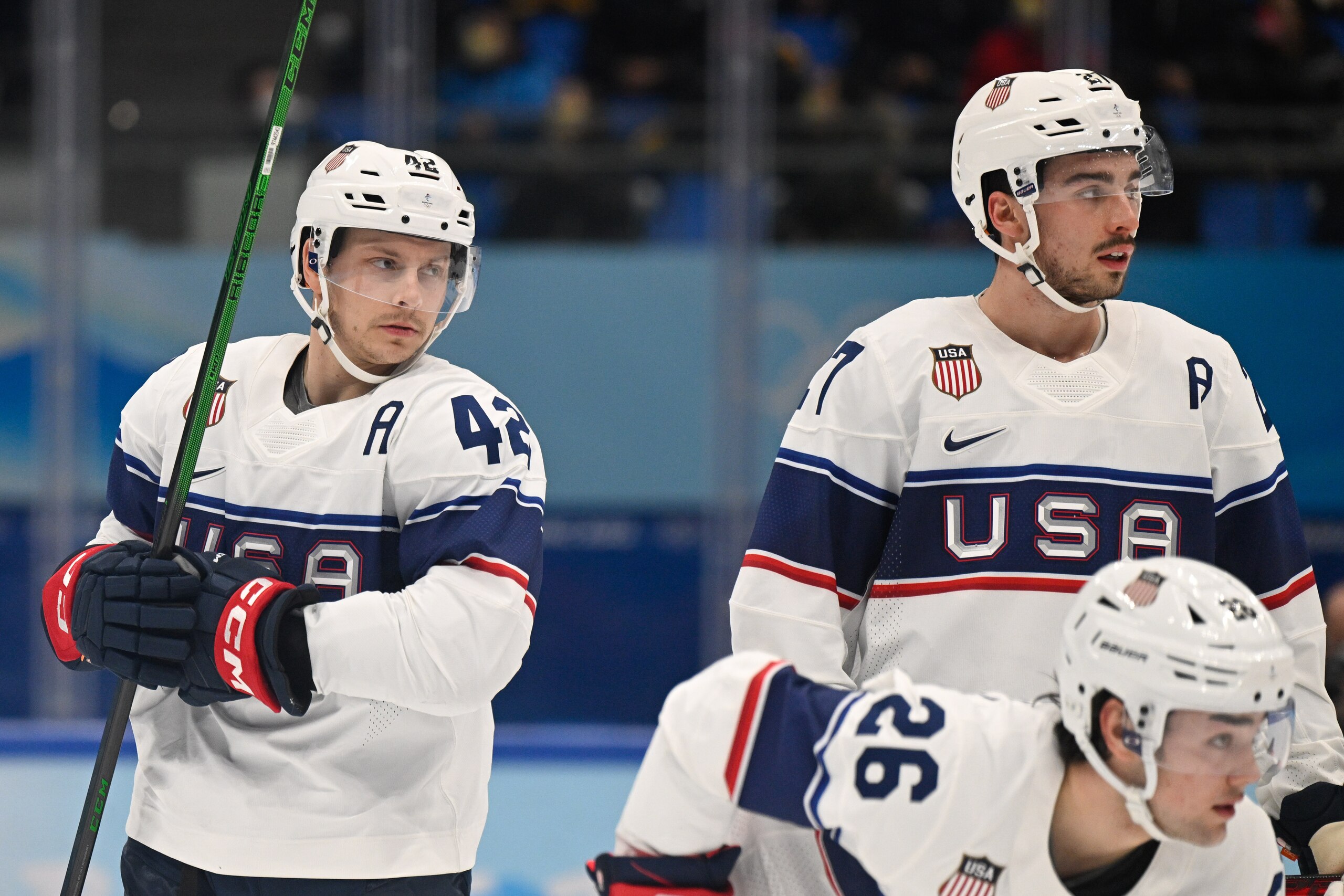 BEIJING, CHINA - FEBRUARY 12: Aaron Ness of USA, Noah Cates of USA and Sean Farrell of USA look on at the men's ice hockey group A preliminary round match between Canada and USA during the Beijing 2022 Winter Olympics at National Indoor Stadium on February 12, 2022 in Beijing, China. (Photo by Mario Hommes/DeFodi Images via Getty Images)