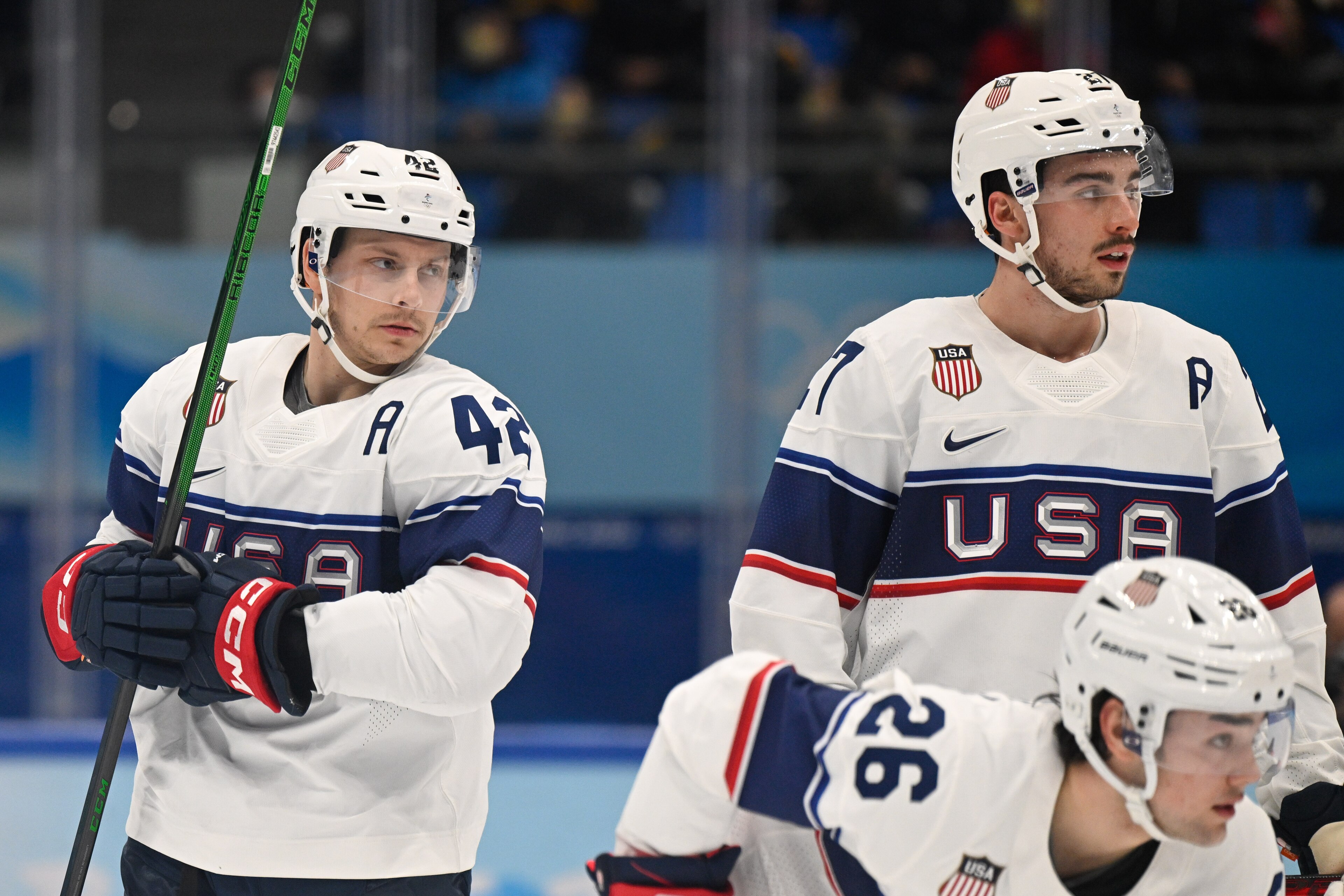 BEIJING, CHINA - FEBRUARY 12: Aaron Ness of USA, Noah Cates of USA and Sean Farrell of USA look on at the men's ice hockey group A preliminary round match between Canada and USA during the Beijing 2022 Winter Olympics at National Indoor Stadium on February 12, 2022 in Beijing, China. (Photo by Mario Hommes/DeFodi Images via Getty Images)