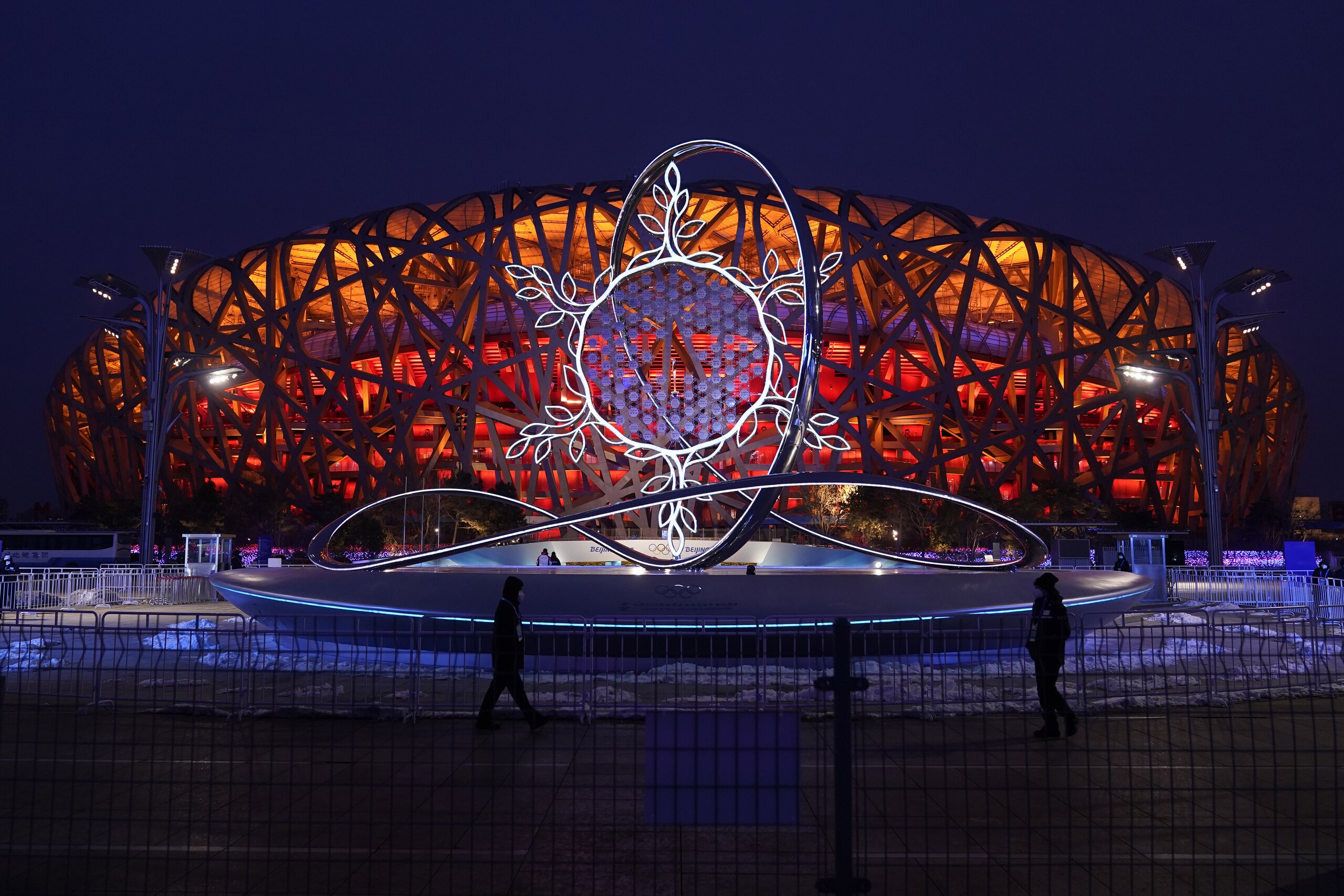 The Olympic flame burning in the center of the snowflake-shaped cauldron is on display near the National Stadium at the 2022 Winter Olympics, Thursday, Feb. 17, 2022, in Beijing. (AP Photo/Jae C. Hong)